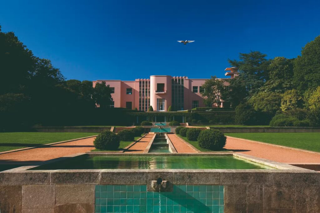 Casa de Serralves, a pink Art Deco home with formal gardens and a fountain.